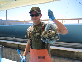 Brad Pitt look alike holds up our bag of 50 oysters - yum!